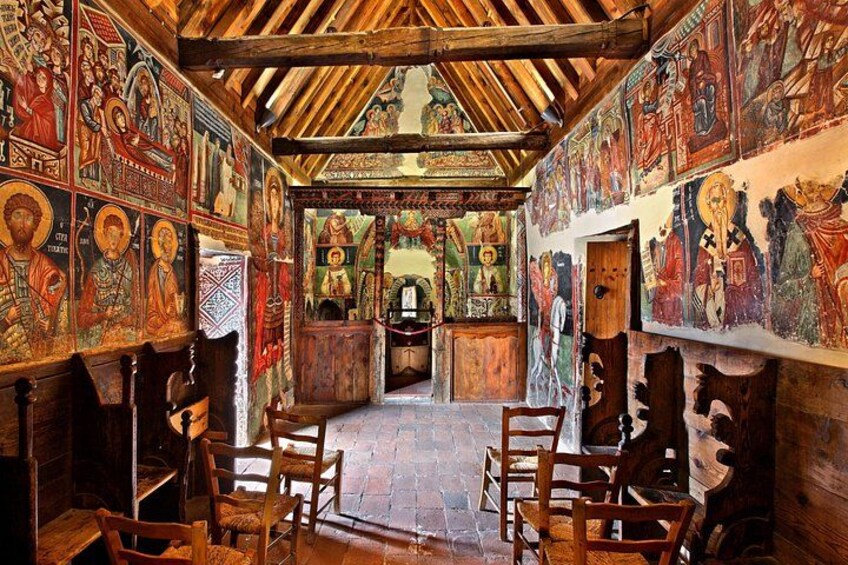An interior with wooden beams, religious iconography, and a central altar. 4