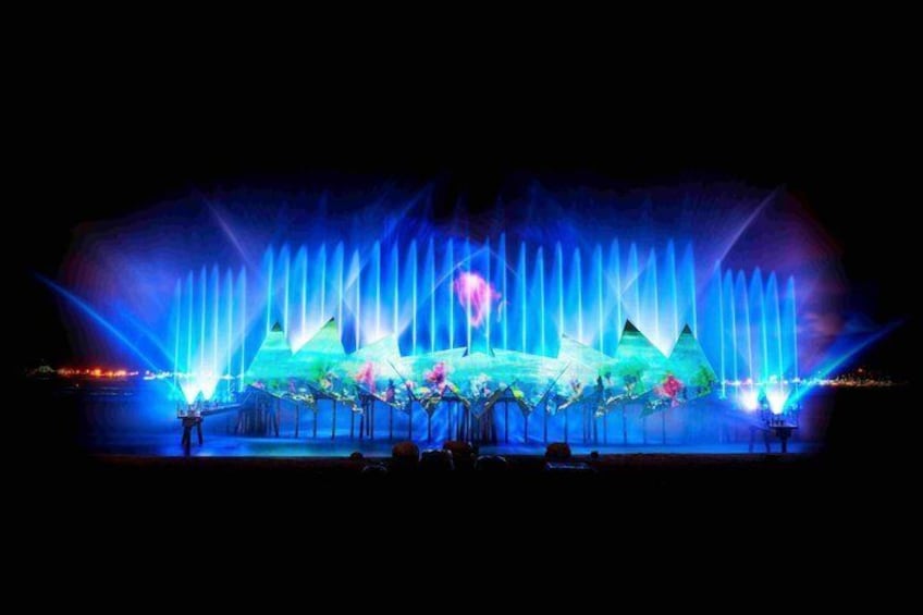 A nighttime fountain show with water jets and lights. 3