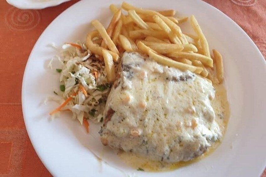 A plate with fish, fries, and coleslaw. 5