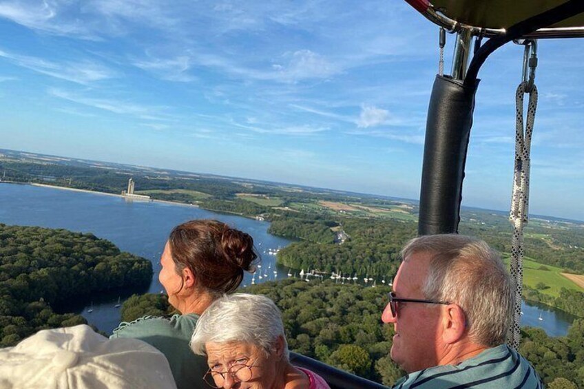 A helicopter flight over a river with a bridge in the distance. 4