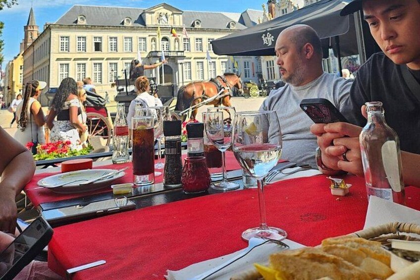 A dining table with food, drinks, and a bottle. 4