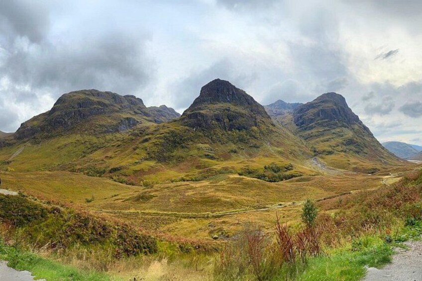 A mountainous landscape with rolling hills and a winding road. 2