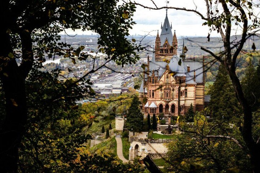 A historic building with intricate architecture, surrounded by lush greenery and a pathway leading to it. 2