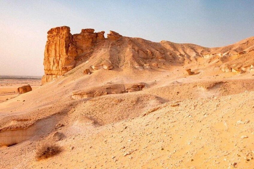 A desert landscape with rocky formations and a clear sky. 2