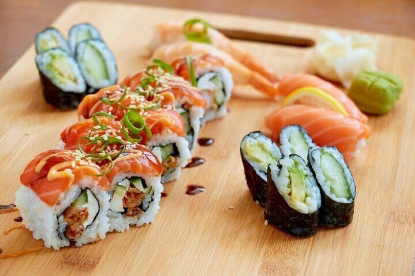 Sushi rolls with salmon and cucumber on a wooden board. 2