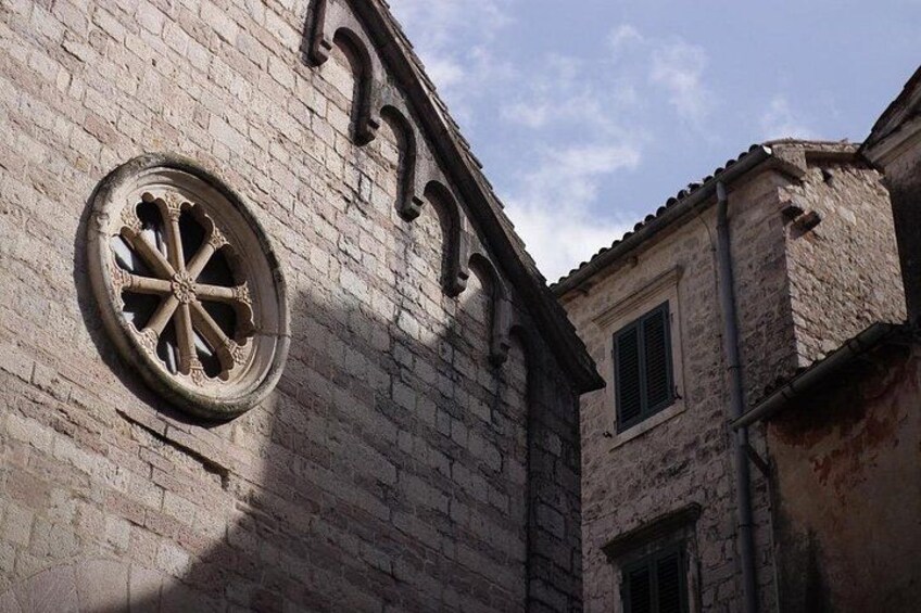 A historic building with a large circular window and arched windows. 5