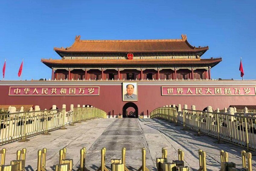 A traditional Chinese building with a red roof and a large portrait in the center. 2