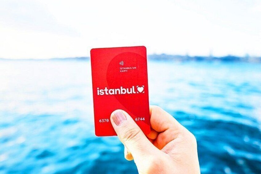A hand holding a red Istanbul Kart card with the number 6370 and 6744. 4