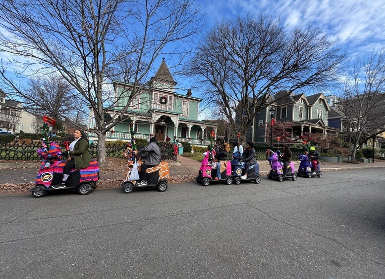 People riding decorated scooters on a street. 5