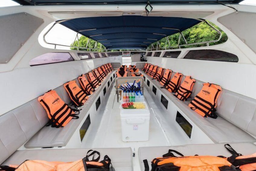 A boat interior with life jackets and a cooler. 5