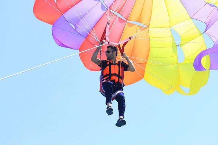 A person skydiving with a parachute. 5