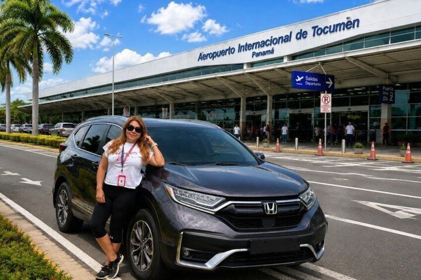 A black SUV parked in front of the Aeropuerto Internacional de Tocumen in Panama. 1