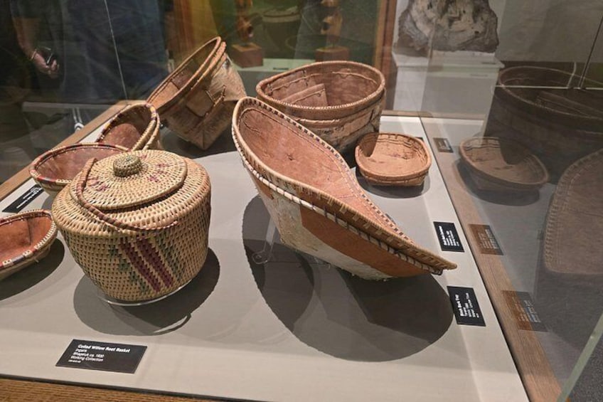 A display of ancient woven baskets and containers, likely from a museum exhibit. 3