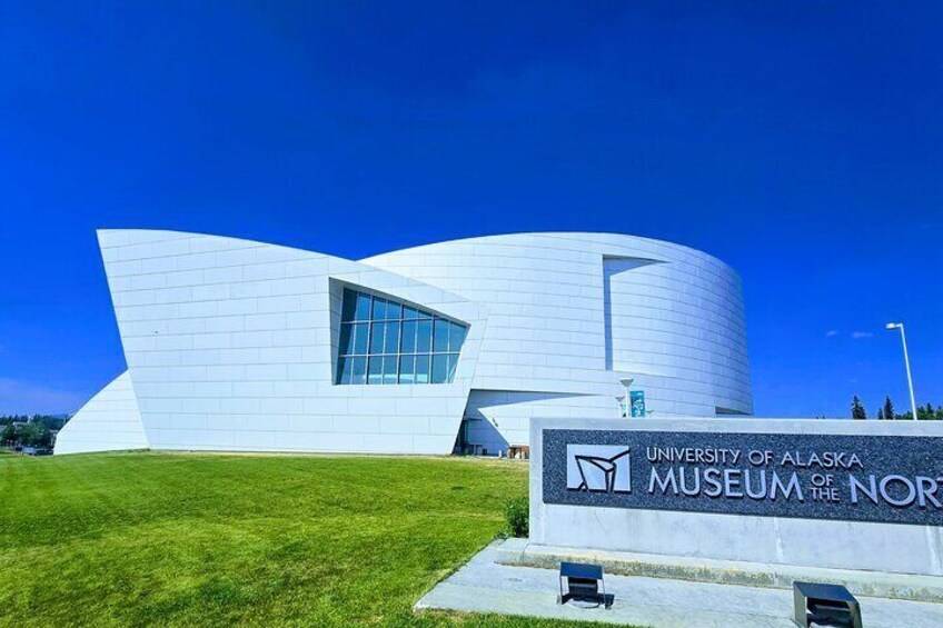 The University of Alaska Museum of the North building with a modern design and a grassy lawn in front. 5
