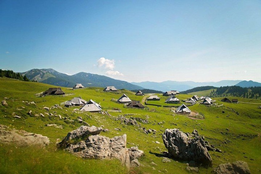 A rural landscape with scattered traditional houses and mountains in the background. 3