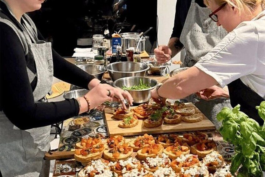 Un groupe de personnes prépare des plats à une table, en utilisant différents ingrédients. 1