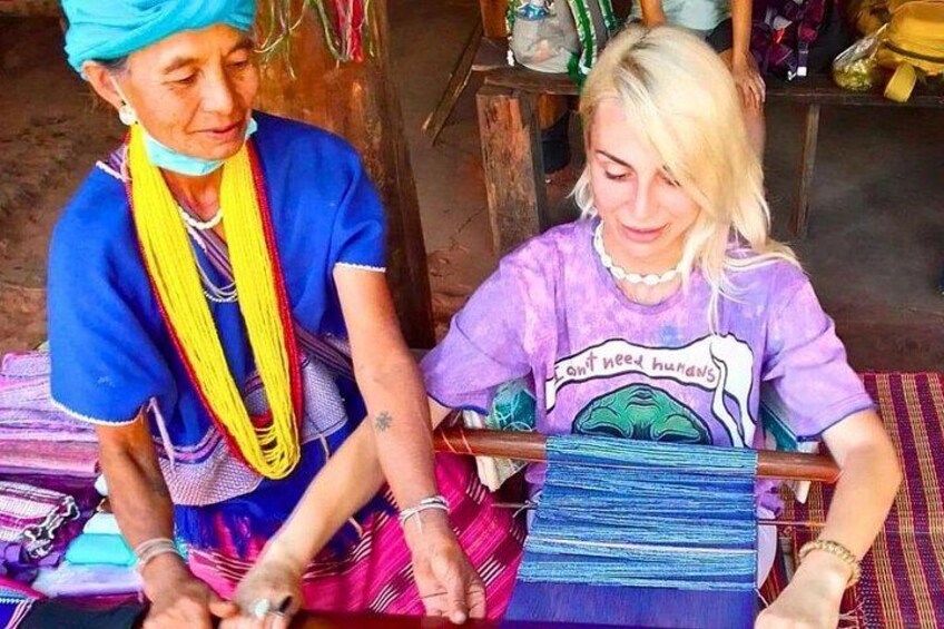 Two people weaving with colorful threads. 5