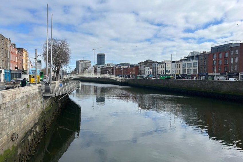 A canal with buildings on both sides, a bridge, and a clear sky. 3