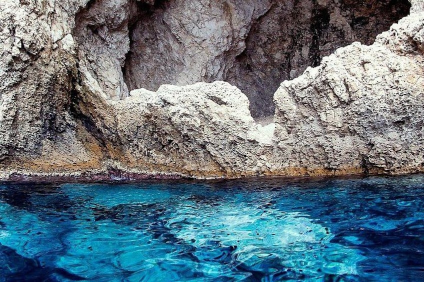 A rocky coastline with clear blue water. 3