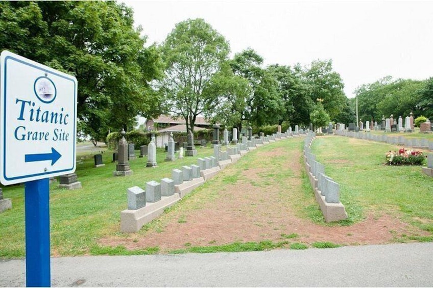A cemetery with a sign indicating the Titanic Grave Site. 4