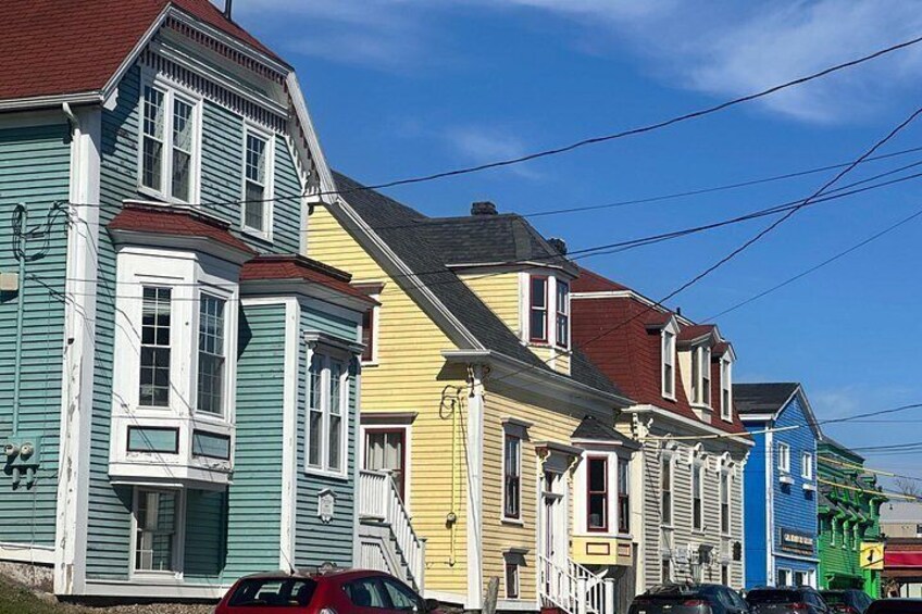 A row of colorful houses with a clear blue sky. 2