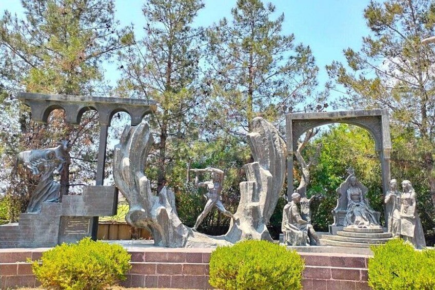 A sculpture garden with various stone sculptures and a clear sky. 3