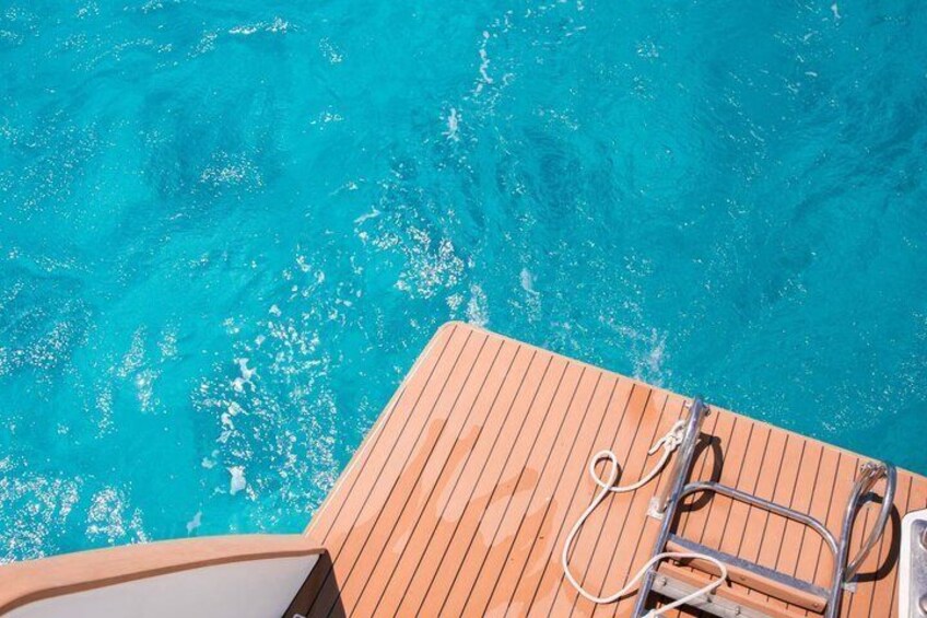 A wooden deck with a metal ladder and a rope. 4