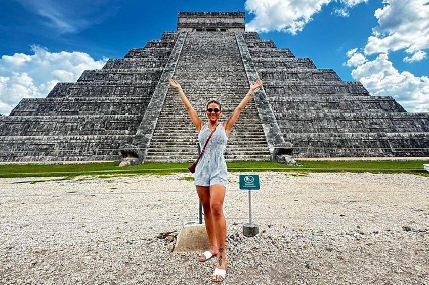 A person standing in front of a large pyramid structure. 5
