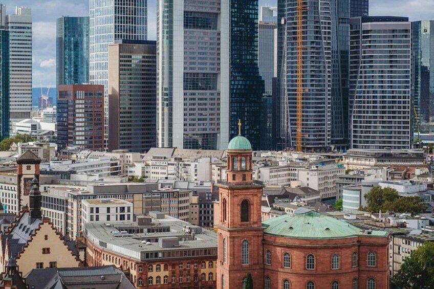 A cityscape with modern skyscrapers and historic buildings. 4