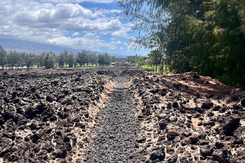 A volcanic landscape with a rugged terrain and sparse vegetation. 5
