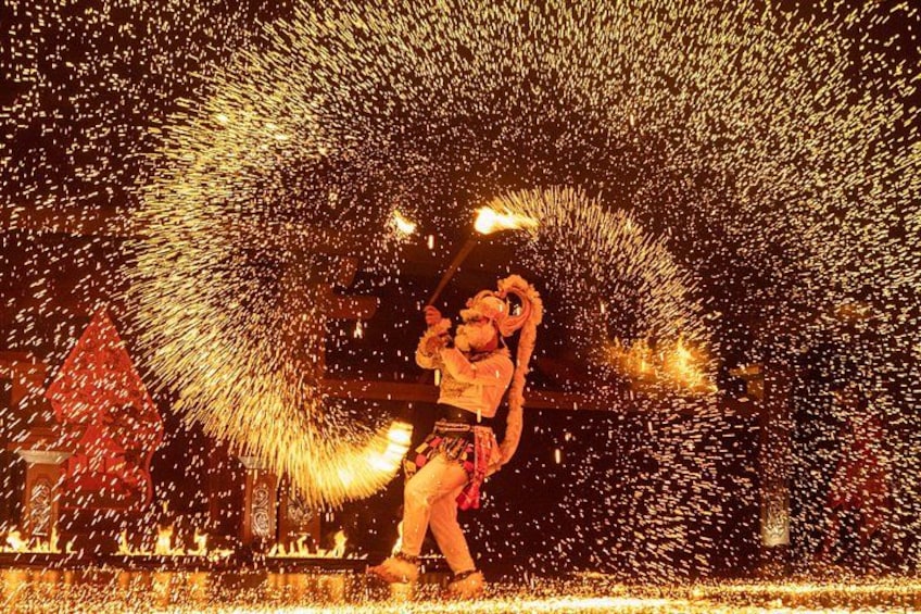 A person performing with fire in a dark setting. 1