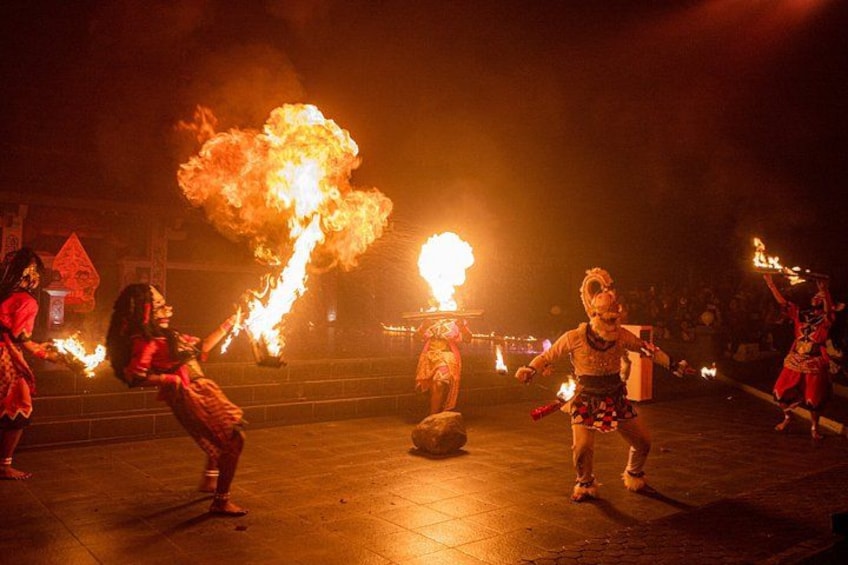 A nighttime outdoor performance with performers using fire props. 2