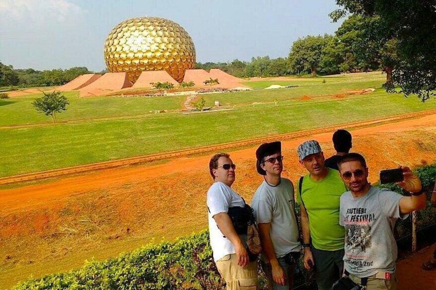 A group of people taking a photo with the geodesic dome in the background. 2