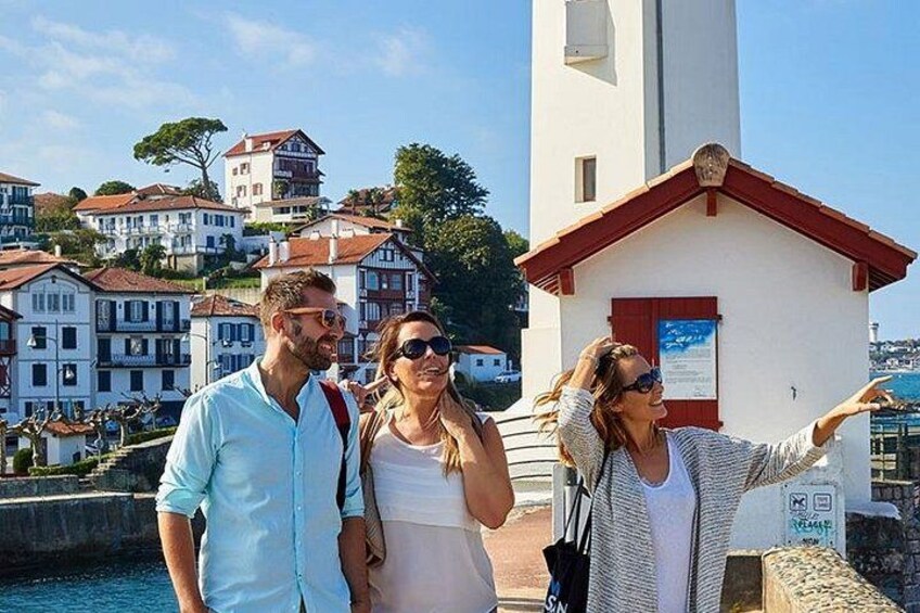 A coastal town with historic buildings, a church, and a clear blue sky. 1