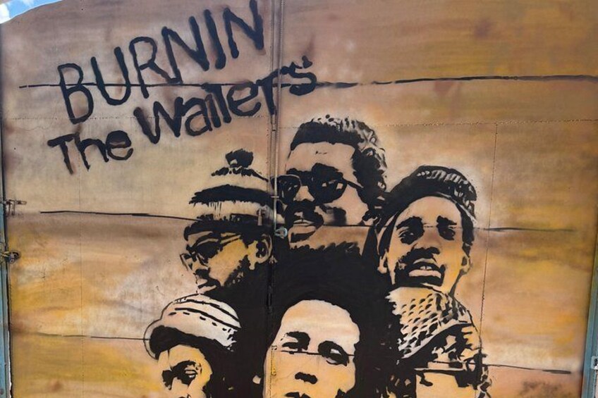 A mural with the text 'BURNIN The Waiters' and a group of stylized faces. 3