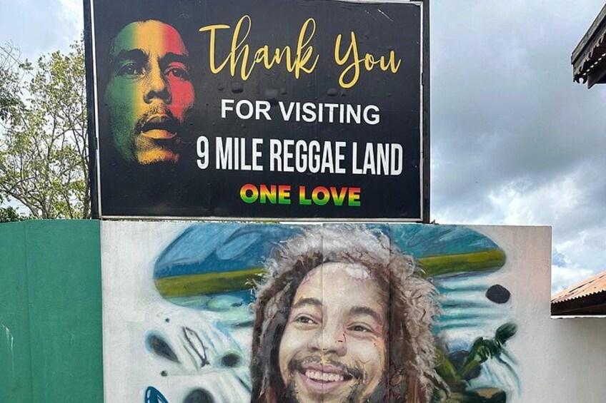 A sign with a message and a mural. 1