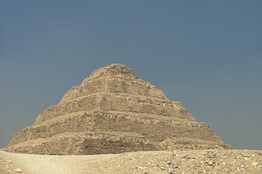 A large pyramid structure with multiple tiers, surrounded by a rocky terrain. 5