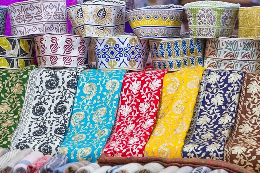 A variety of colorful, patterned fabrics displayed for sale. 4