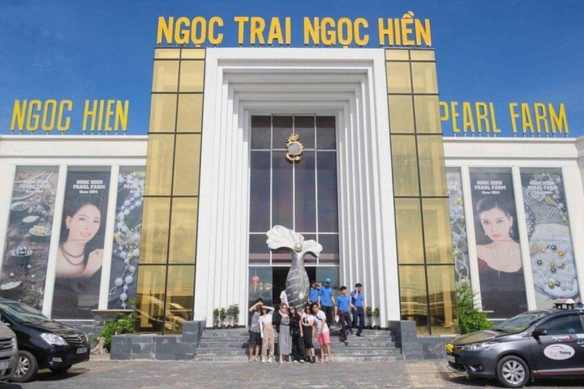 A building with large golden signage reading 'NGOC TRAI NGOC HIEN' and 'PEARL FARM'. 5