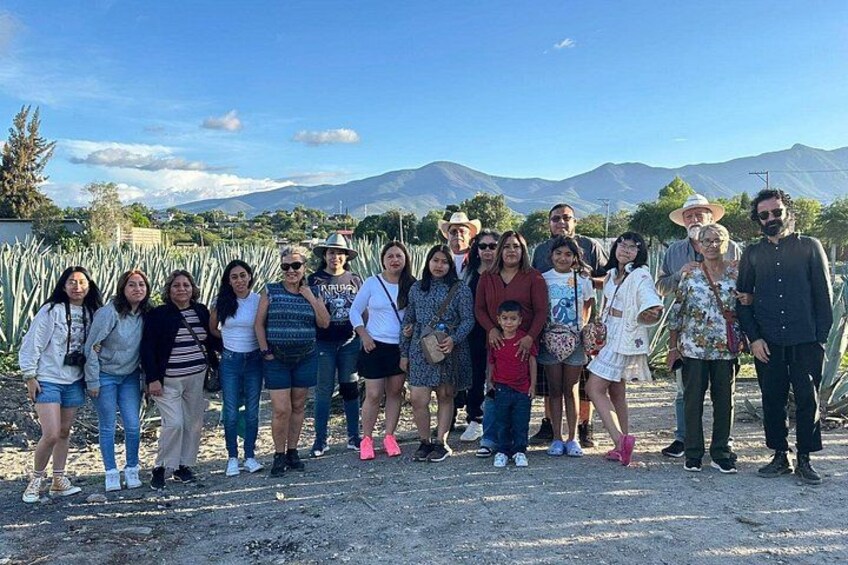 A group of people standing outdoors with mountains in the background. 3