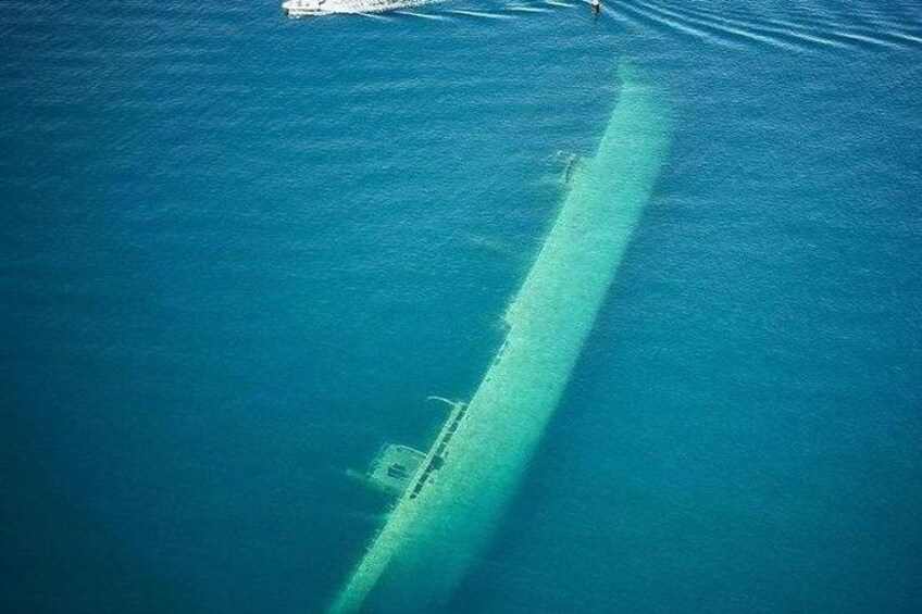 A submerged shipwreck in clear blue water. 2