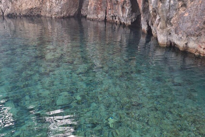 A clear body of water surrounded by rocky cliffs. 5