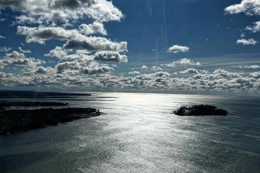 A calm sea with a clear sky and scattered clouds. 2