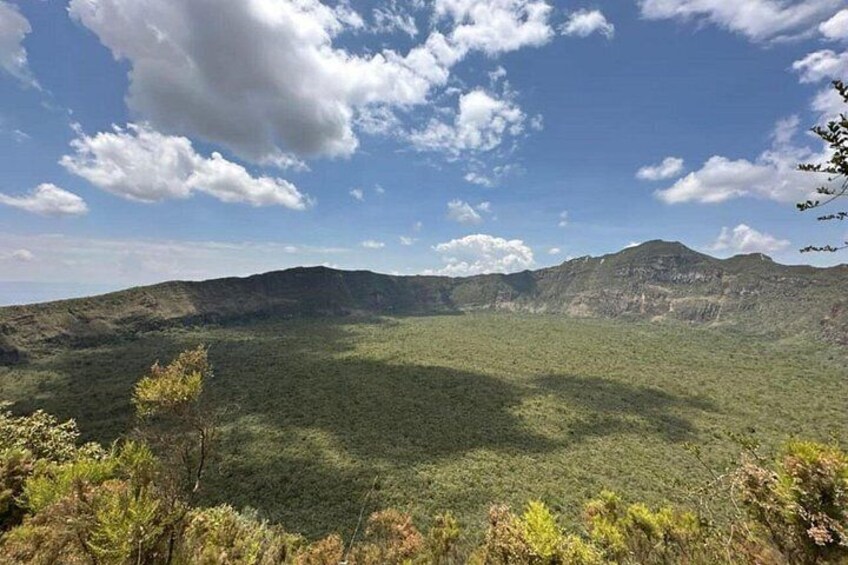 A mountainous landscape with a clear sky and scattered clouds. 2