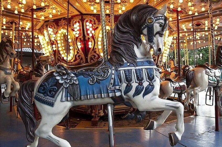 A carousel horse with ornate decorations and lights. 2