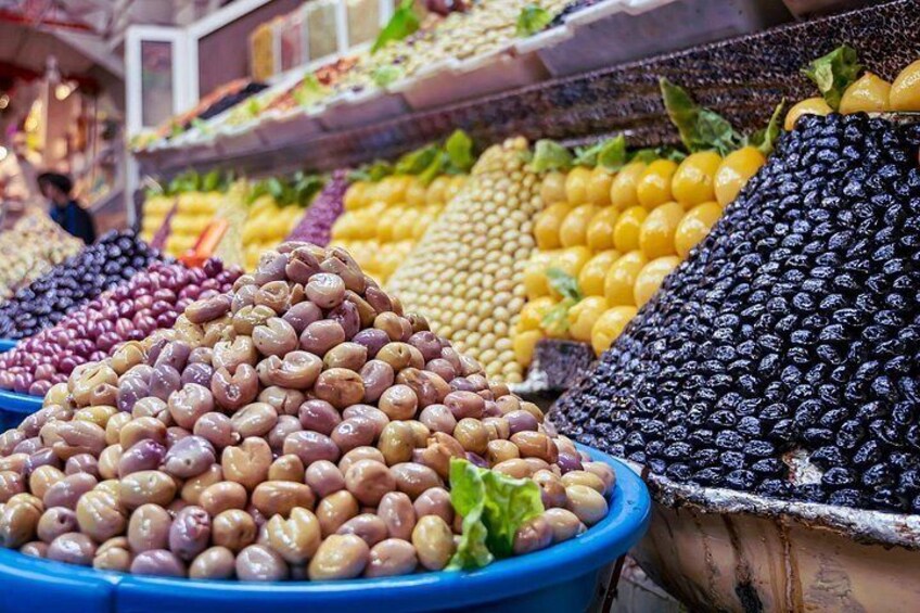 A market with various beans displayed in blue bowls. 2