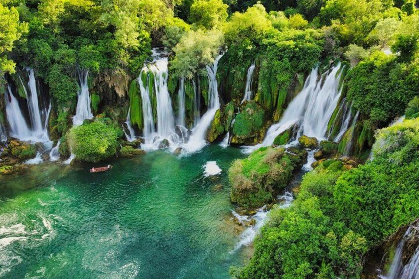 A waterfall surrounded by lush greenery. 2