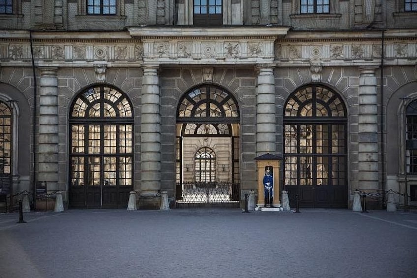 Ein prachtvolles Gebäude mit Bogenfenstern und einer Statue davor. 2