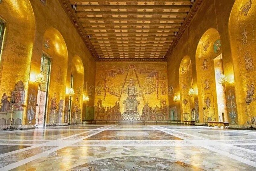 A grand hall with golden walls and a large central figure. 1