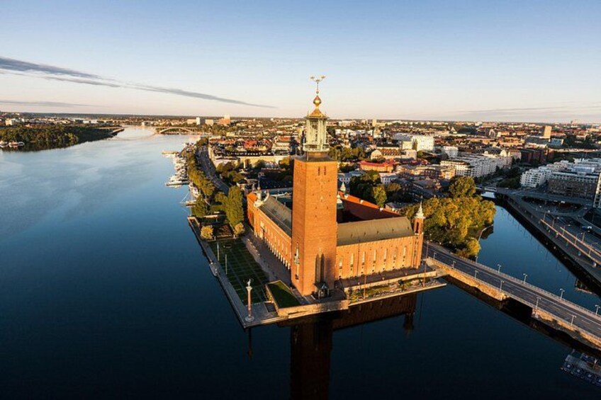 A river with a bridge, a tower, and a building with a clock. 5